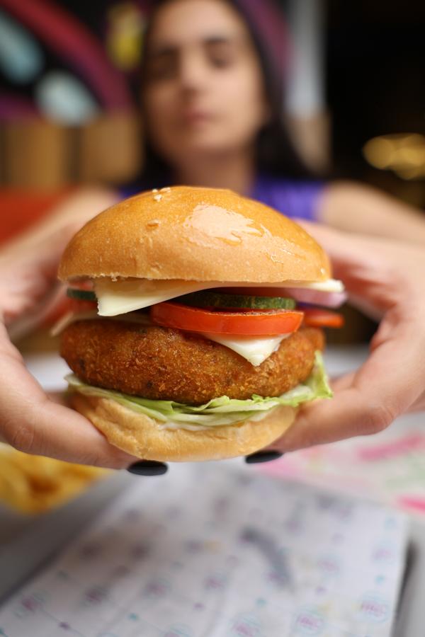 A diner holding the veg crumb fried burger