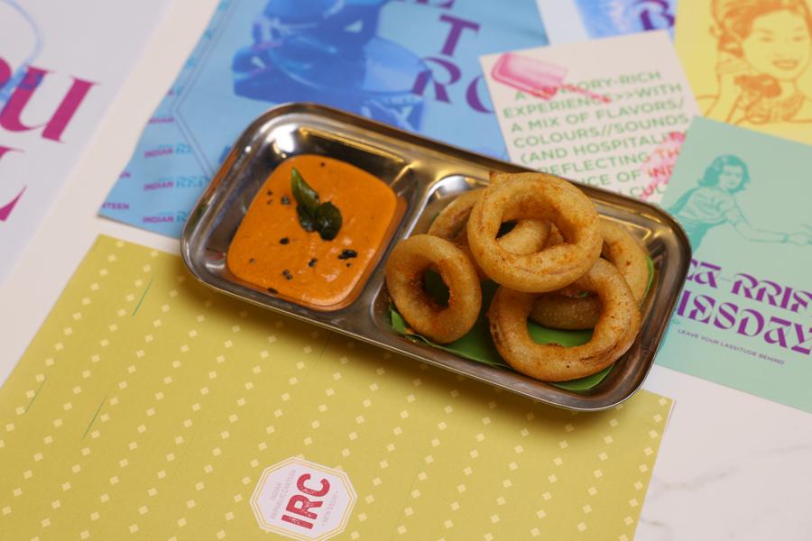 Dosa onion rings and chutney in a steel compartment tray